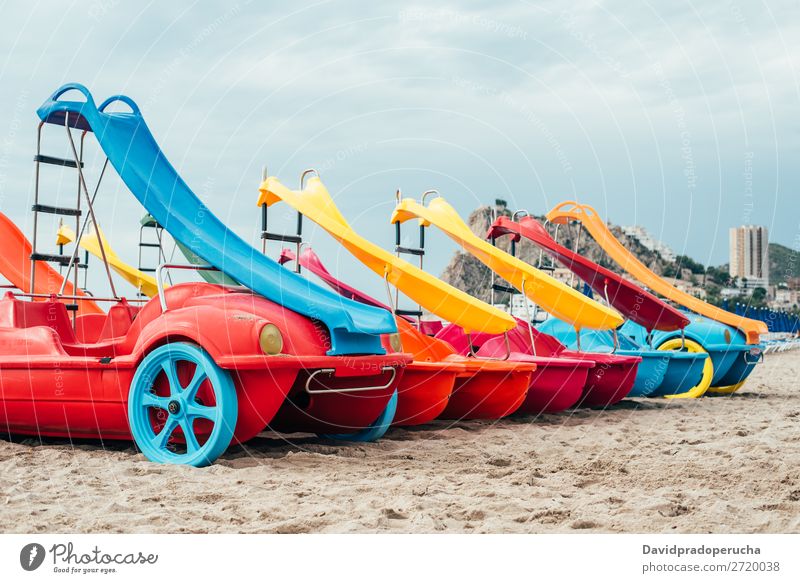 colorful Pedalos on the beach sand Beach Summer Watercraft Multicoloured Paddle Vacation & Travel Catamaran Red Background picture White Yellow Exterior shot