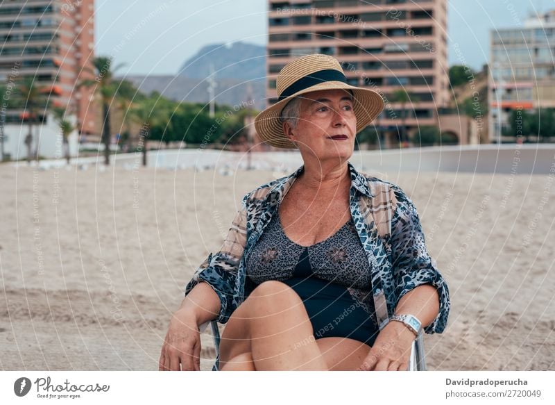 Elderly woman on the beach wearing a straw hat Woman Vacation & Travel Old Beach Senior citizen Leisure and hobbies Caucasian Natural Happy grey hair To enjoy