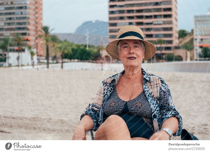 Elderly woman on the beach wearing a straw hat Woman Vacation & Travel Old Beach Senior citizen Leisure and hobbies Caucasian Natural Happy grey hair To enjoy