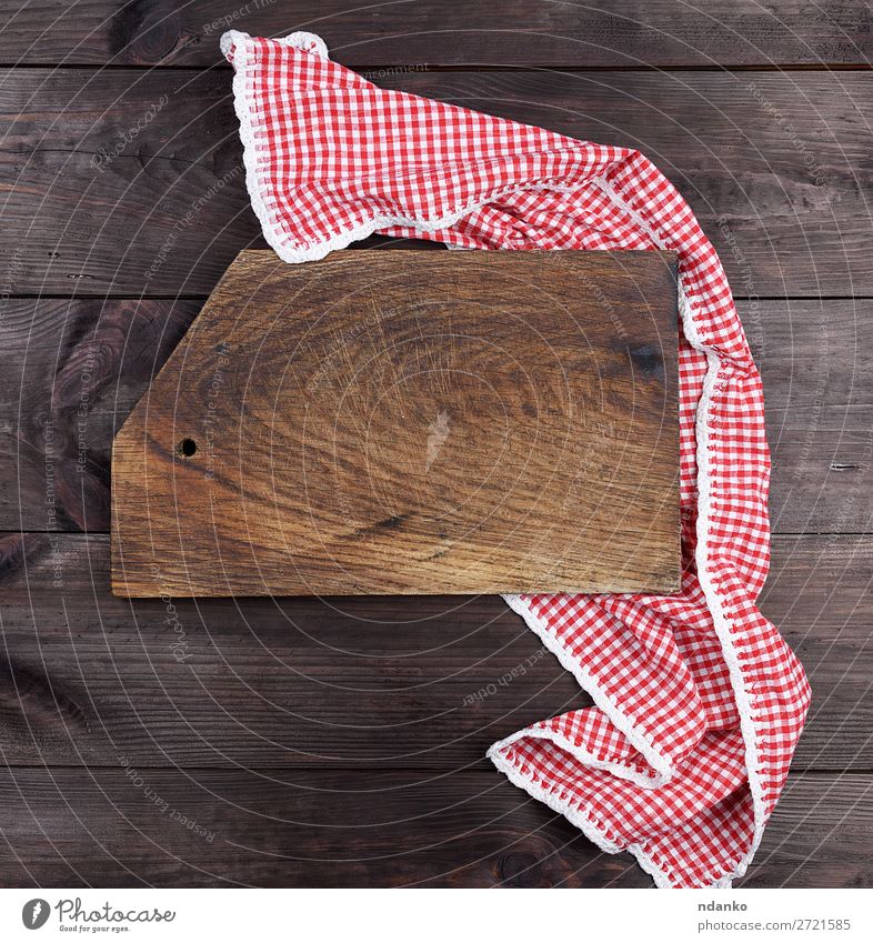 Empty wooden cutting board on a kitchen table. Top view, copy