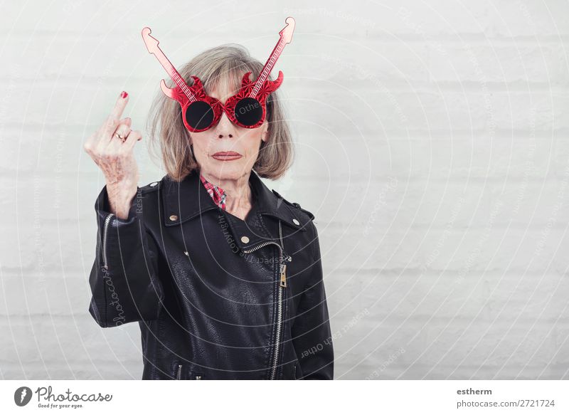 Portrait of senior woman with sunglasses insulting with finger Lifestyle Music Feasts & Celebrations Retirement Human being Feminine Female senior Woman