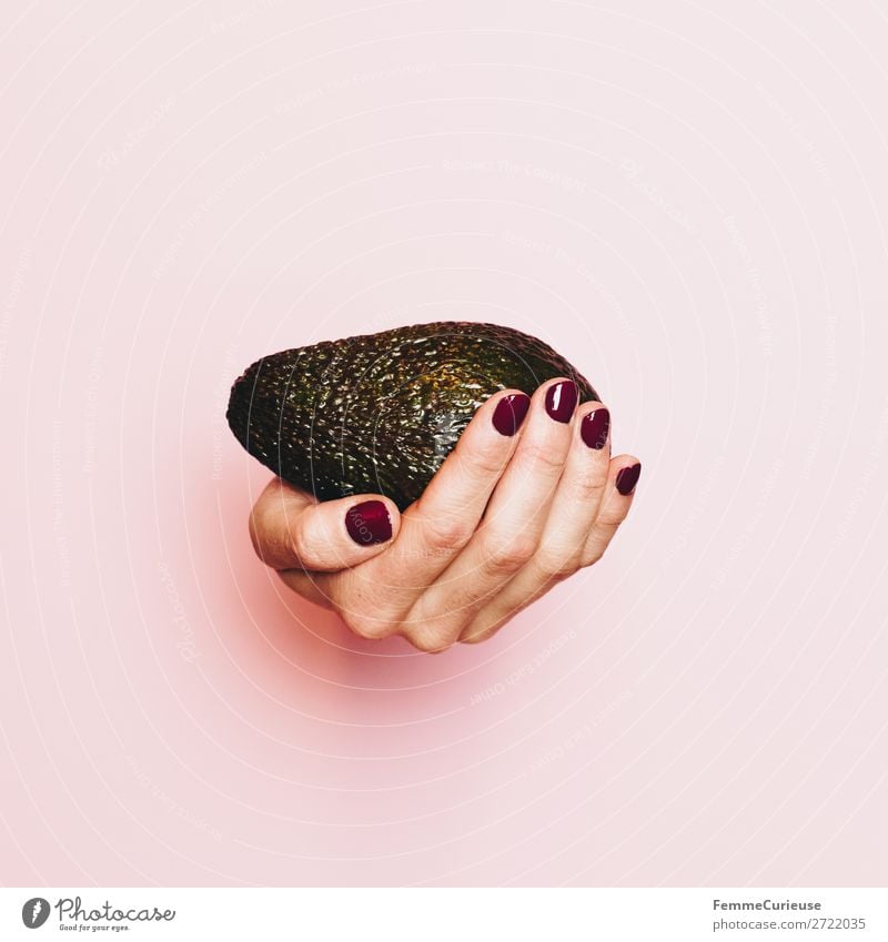 Hand of a woman with avocado in front of pink background Food Nutrition Breakfast Lunch Dinner Buffet Brunch Picnic Organic produce Vegetarian diet Diet