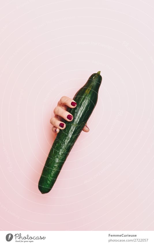 Hand of a woman holding a cucumber Nutrition Breakfast Dinner Picnic Organic produce Vegetarian diet Diet Feminine 1 Human being Healthy Cucumber Green Pink
