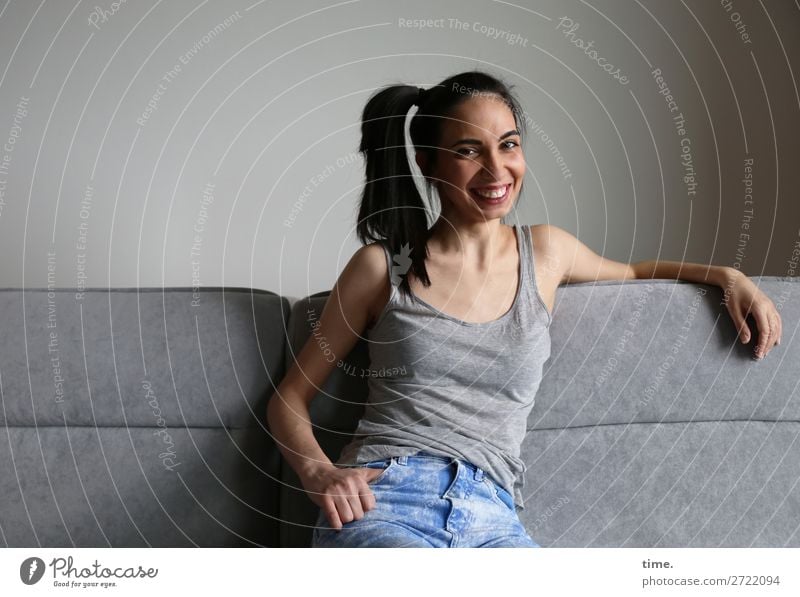 GizzyLovett Sofa Room Feminine Woman Adults 1 Human being T-shirt Jeans Black-haired Long-haired Braids To hold on Smiling Laughter Looking Sit Friendliness
