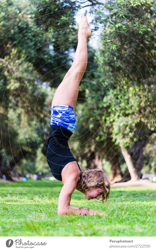 Young girl standing on her head doing yoga in the park Lifestyle Beautiful Body Relaxation Meditation Summer Sports Yoga Human being Woman Adults Nature Autumn