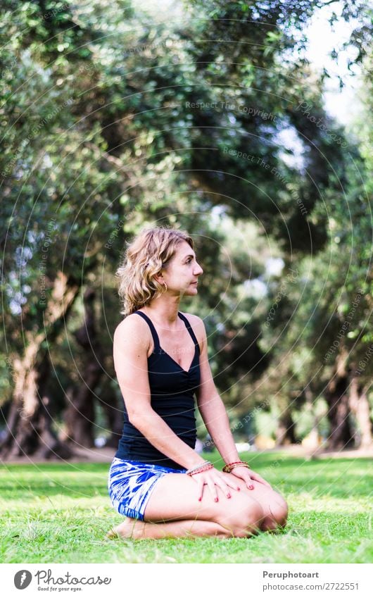 Pretty woman doing yoga exercises in the park. - a Royalty Free Stock Photo  from Photocase