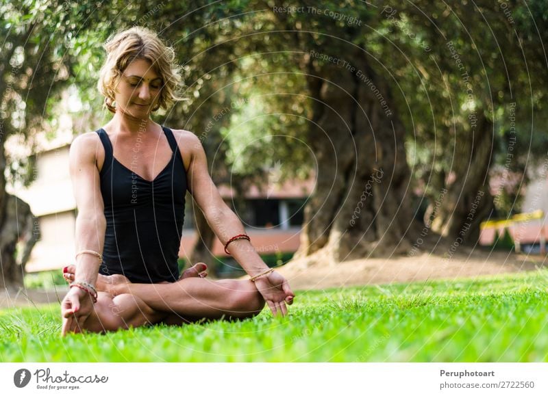 Middle-aged Blonde Woman, Wearing Green Leggings and White Top, Doing  Meditation and Yoga Exercises Outdoors. Concept Yoga, Stock Image - Image  of lotus, woman: 270683655