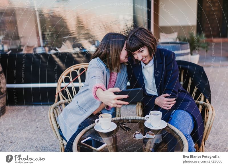 two friends in a terrace taking a selfie Beverage Coffee Tea Lifestyle Elegant Joy Happy Beautiful Leisure and hobbies Vacation & Travel To talk Cellphone