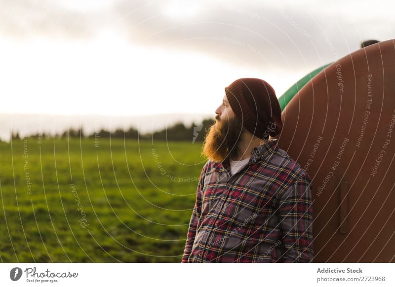 Thoughtful man leaning on barrel Tourist Field Green Landscape Nature Sky Summer bearded Lean Keg Rust Old Looking away Considerate Vacation & Travel Tourism