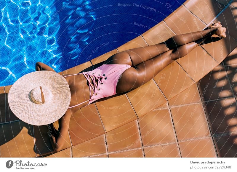 Black woman lying down in a swimming pool side African Anonymous Rear view Barefoot Beautiful Blue Copy Space Crops Ethnic Faceless Woman Girl Healthy