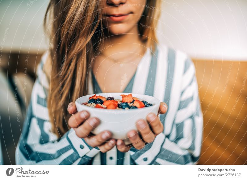 Crop woman close up eating oat and fruits bowl for breakfast Bowl Breakfast Woman Cereal porridge Hand Crops Anonymous Unrecognizable Strawberry Blueberry Oats