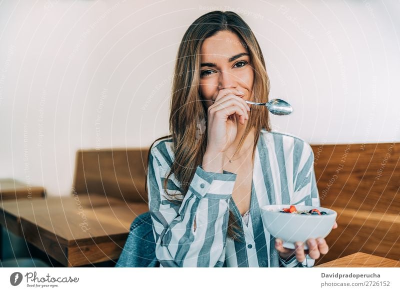 woman close up eating oat and fruits bowl for breakfast Bowl Breakfast Woman Cereal porridge Hand Smiling Crops Strawberry Blueberry Oats Healthy Food White