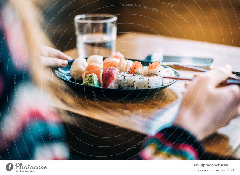 Crop woman eating sushi Sushi Woman Hand Food soy maki california roll Chopstick Roll Crops Unrecognizable Anonymous Close-up Portrait photograph Salmon