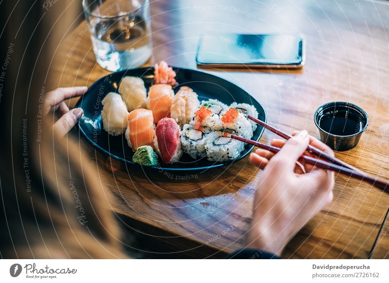 Crop woman eating sushi Sushi Woman Bird's-eye view Hand Food soy maki california roll Chopstick Roll Crops Unrecognizable Anonymous Close-up