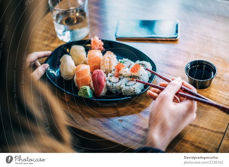 Sushi Set nigiri and sushi rolls on rectangular wooden plates