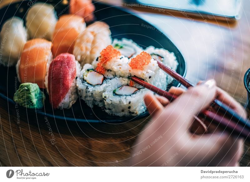 Crop woman eating sushi Sushi Woman Hand Food soy maki california roll Chopstick Roll Crops Unrecognizable Anonymous Close-up Portrait photograph Salmon