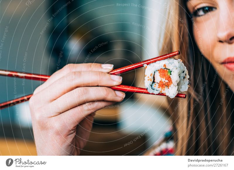 Crop woman eating sushi Sushi Woman Smiling Hand Food soy maki california roll Chopstick Roll Crops Unrecognizable Anonymous Close-up Portrait photograph Salmon