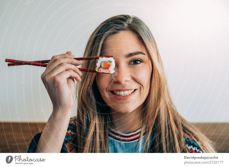 woman covering her eye with piece of sushi Sushi Woman Smiling Hand Food soy maki california roll Chopstick Roll Crops Unrecognizable Anonymous Close-up