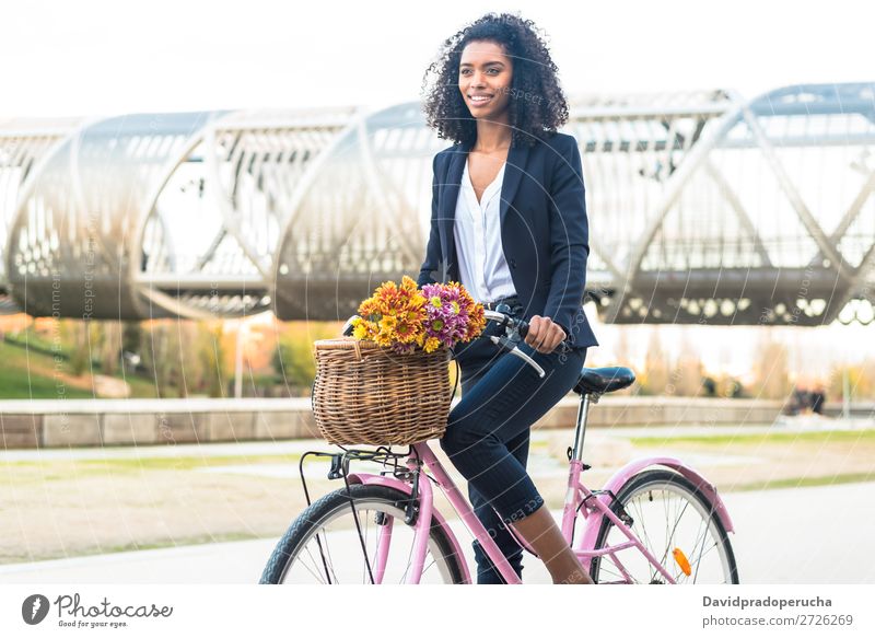 Business black woman riding a vintage bicycle in the city Woman Bicycle Cycling Vintage Black Mixed race ethnicity City Youth (Young adults) Human being Suit