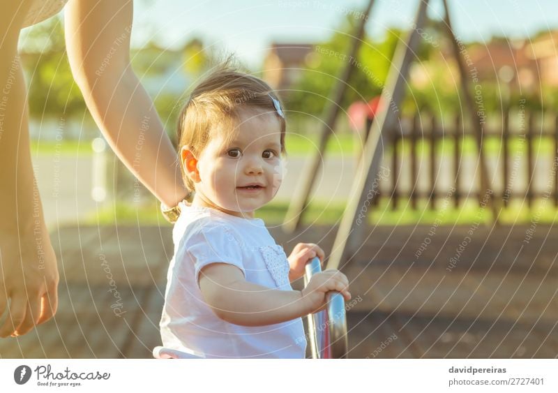 Baby girl playing over a seesaw swing on the park Lifestyle Joy Happy Beautiful Relaxation Leisure and hobbies Playing Freedom Summer Sun Child Toddler Woman