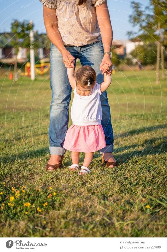 Baby girl learning to walk with his mother on grass Lifestyle Joy Happy Leisure and hobbies Summer Garden School Human being Toddler Woman Adults Mother