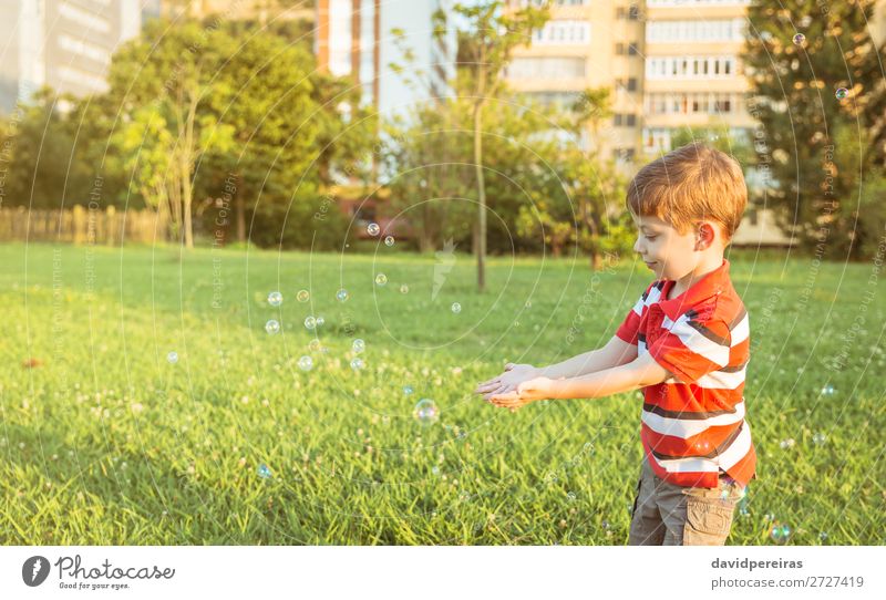 Happy boy playing with soap bubbles in the park Lifestyle Joy Beautiful Relaxation Leisure and hobbies Playing Freedom Summer Garden Child Human being