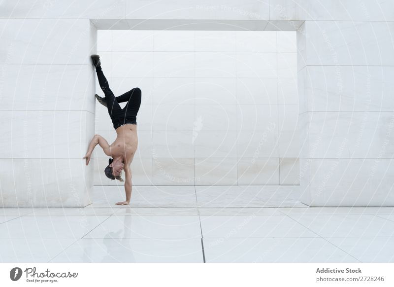 Man in handstand inside Acrobatic Handstand Balance Athletic Joie de vivre (Vitality) Sports Breakdance flexibility Youth (Young adults) pose Power Studio shot
