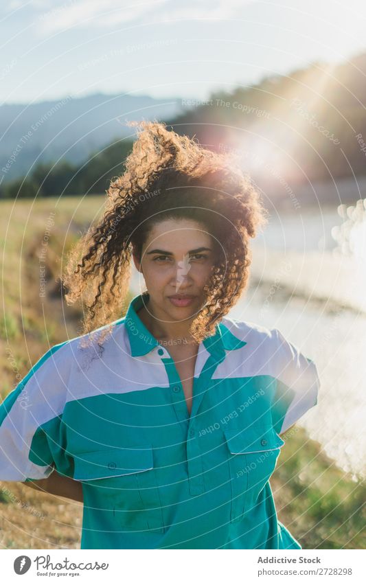 Curly woman posing on nature in sunlight Woman Summer To enjoy Posture human face Landscape Nature Colour Portrait photograph tranquil Exterior shot Countries