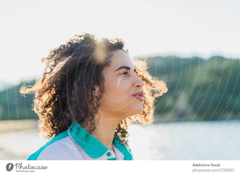 Curly woman posing on nature in sunlight Woman Summer To enjoy Posture human face Landscape Nature Colour Portrait photograph tranquil Exterior shot Countries