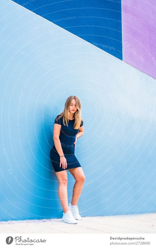 Happy beautiful young woman posing by a colorful wall Woman Multicoloured Blonde Smiling Fashion Model Red Youth (Young adults) Stand Face Girl Loneliness