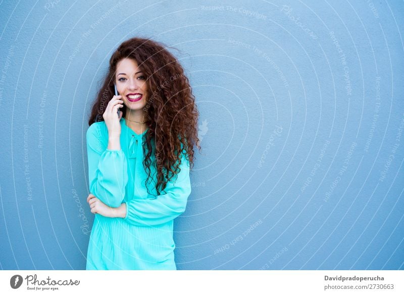 Happy young woman on the mobile phone by a colorful wall Woman Red-haired Telephone Business Businesswoman Technology Mobile Smiling Face Beauty Photography