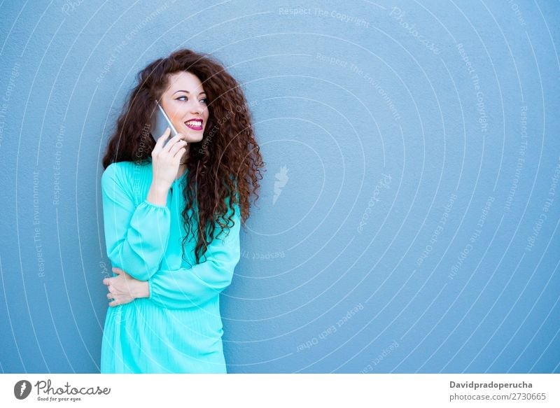 Happy young woman on the mobile phone by a colorful wall Woman Red-haired Telephone Business Businesswoman Technology Mobile Smiling Face Beauty Photography