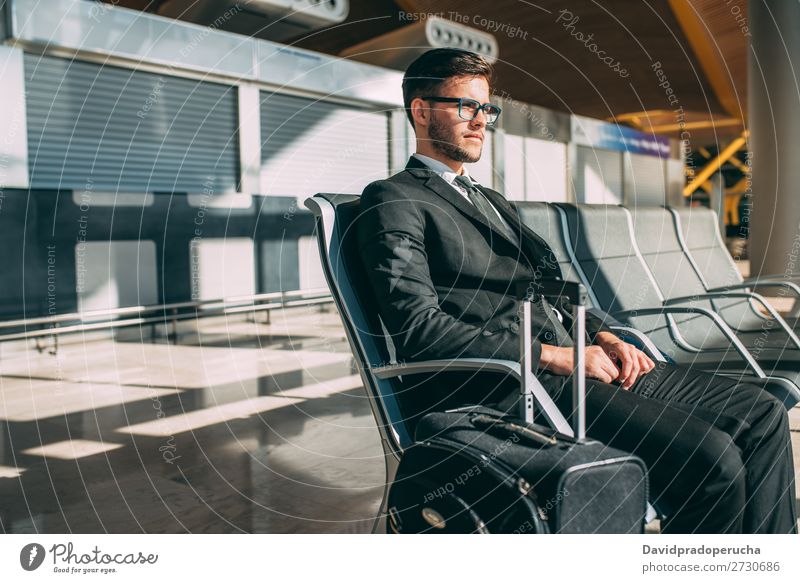 Young business man sitting at the airport waiting for the flight Lifestyle Vacation & Travel Trip Work and employment Business Human being Man Adults Airport