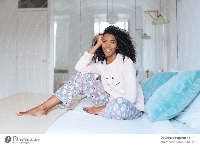 Happy beautiful young black woman relaxed sitting in the bed Woman Black Smiling Relaxation Beautiful awake Cute Bed Cozy Pyjama pajama Winter Cold Sit