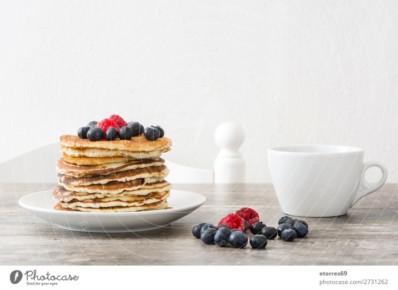 pancakes with raspberries and blueberries on wooden table Pancake Candy Dessert Breakfast Blueberry Raspberry Berries Red Baking Food Healthy Eating
