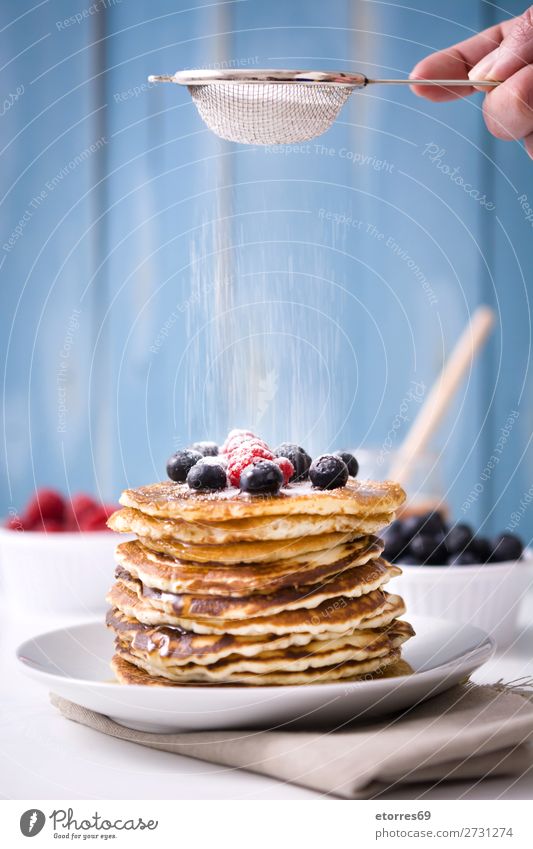 Pouring sugar Pancakes with raspberries and blueberries Candy Dessert Breakfast Blueberry Raspberry Berries Red Baking Food Healthy Eating Food photograph Dish