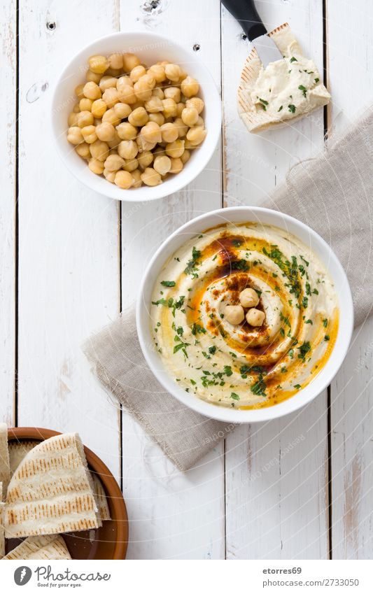 Hummus in bowl and pita bread on white wooden table. Bread Food Healthy Eating Dish Food photograph Nutrition Chickpeas Coriander Lemon Olive oil Vegan diet