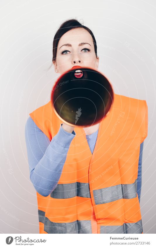 Woman in warning vest making announcement with megaphone Feminine Adults 1 Human being 18 - 30 years Youth (Young adults) 30 - 45 years Communicate Remark Warn