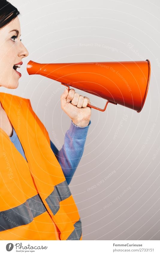 Woman in warning vest making announcement with megaphone Feminine 1 Human being Communicate Respect Warn high-visibility vest Vest Orange Red Megaphone Strike