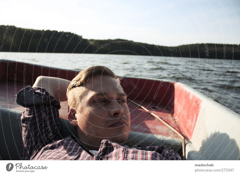 Portrait young man eye contact lying in a rowing boat Lifestyle Wellness Harmonious Well-being Contentment Relaxation Calm Meditation Vacation & Travel Tourism