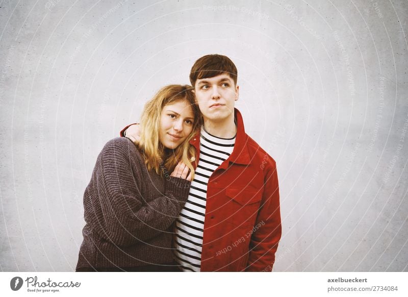 young couple stands in front of a concrete wall with free space for text Lifestyle Human being Masculine Feminine Young woman Youth (Young adults) Young man