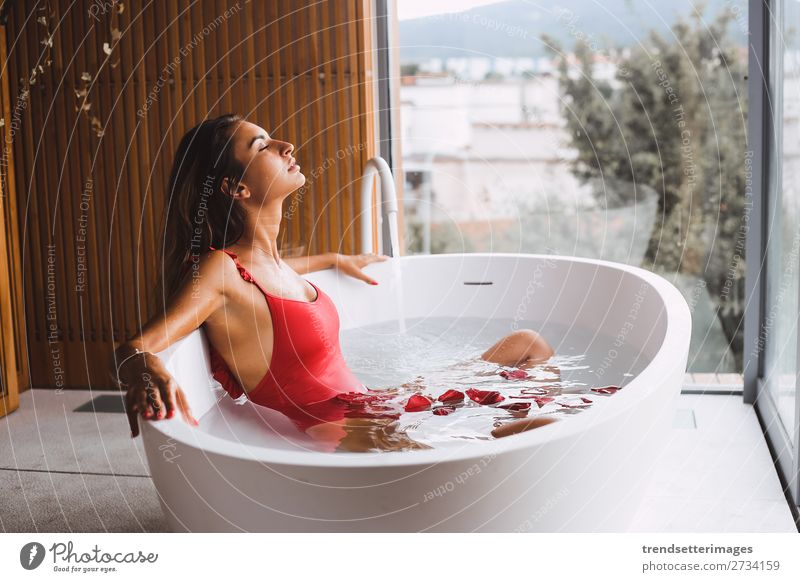 Women's legs in the bathtub, bathing with bubble bath foam top view,  relaxtion beauty spa concept - a Royalty Free Stock Photo from Photocase