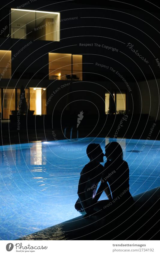 Romantic couple kissing at the pool in the night Joy Happy Beautiful Swimming pool Vacation & Travel Summer Woman Adults Man Couple Kissing Love Dark Blue
