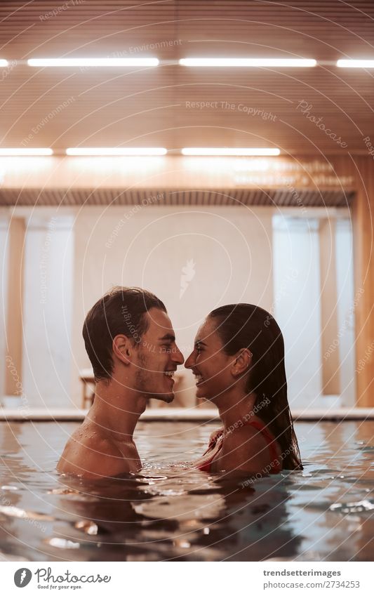 Couple In Love At Luxury Hotel Lifestyle Joy Happy Beautiful Wellness Relaxation Spa Swimming pool Leisure and hobbies Woman Adults Man Waterfall Smiling water