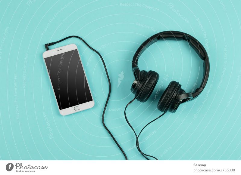 Music online concept - phablet and headphones Leisure and hobbies Table Business Telephone PDA Computer Screen Technology Internet Media Above Smart Blue White