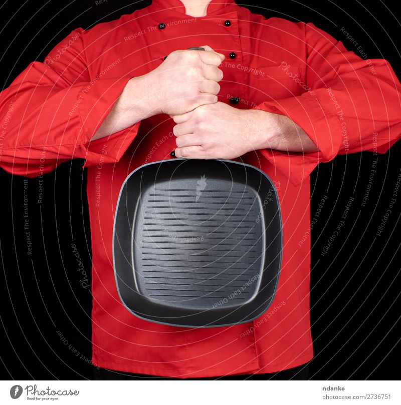 cook in red uniform holding an empty square black frying pan Pan Kitchen Restaurant Cook Human being Man Adults Hand Clothing Red Black Cast iron Caucasian chef