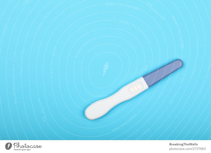 Close up positive pregnancy test over red Healthy Health care Medication Stripe Above Pregnant Blue White Emotions Moody Anticipation Optimism Discover Happy