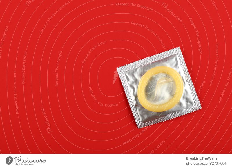 Close up one condom pack over red background Healthy Health care Medication Above Clean Red Protection Responsibility Caution Contact Testing & Control Condom