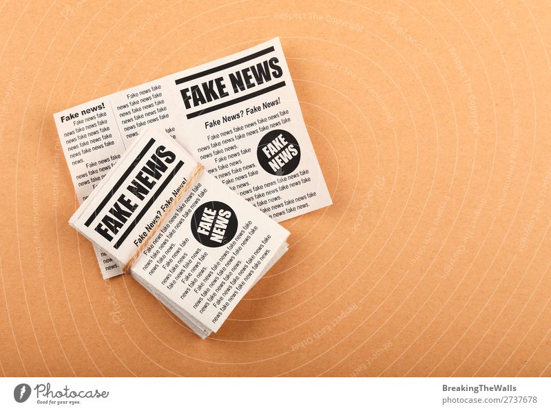 Stack of FAKE NEWS newspapers over brown paper To talk Media Print media Newspaper Magazine Reading Paper Signs and labeling Signage Warning sign Brown False