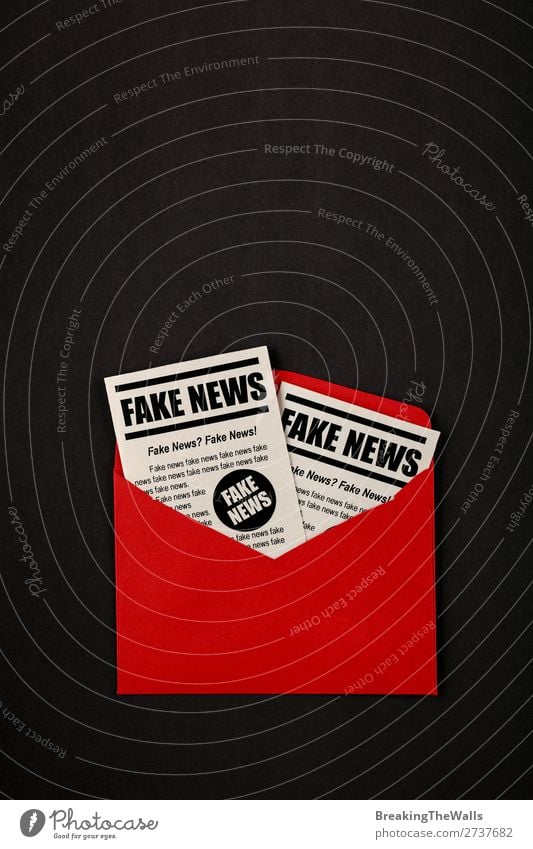Envelope with FAKE NEWS newspapers over black Mail Media Print media New Media Email Newspaper Magazine Paper Red Black False Colour fake Journalism issue